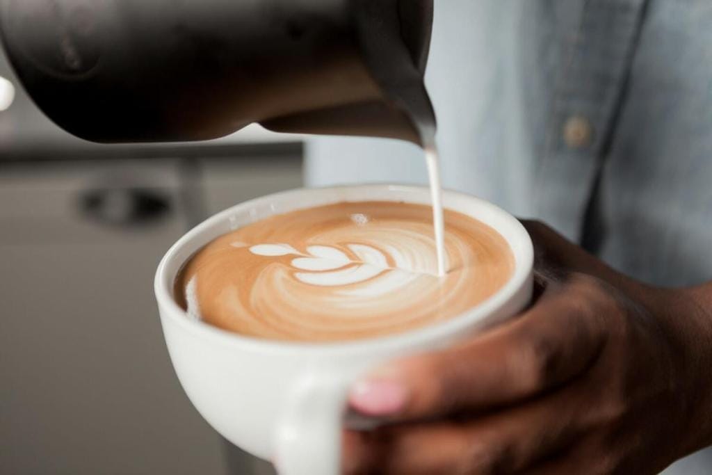 Barista pouring latte art at the RNY Lab