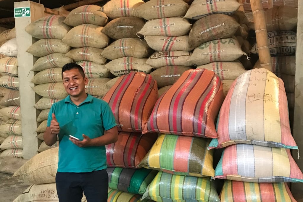 producer in front of coffee from colombia