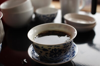 brewed puer tea in a tea cup
